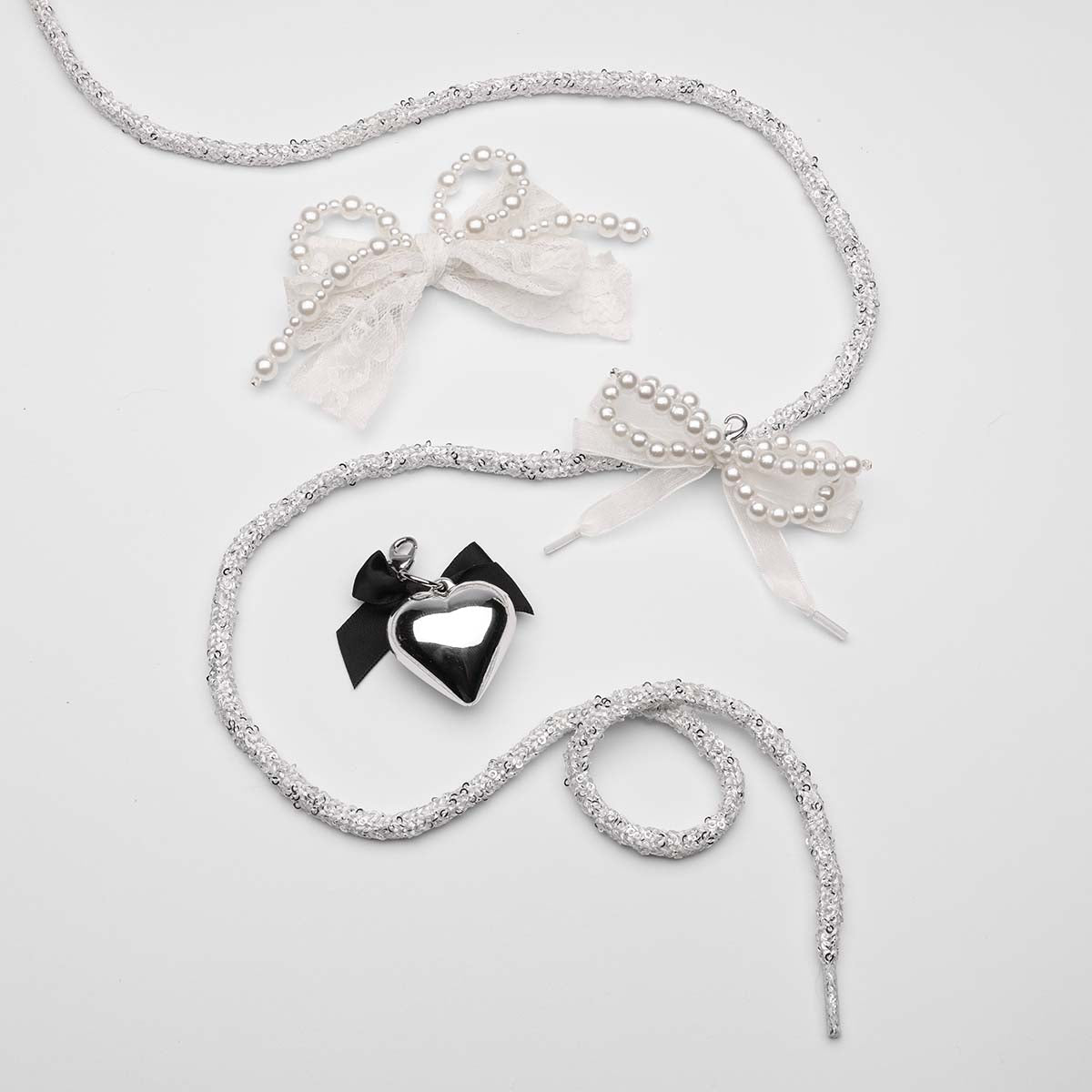 Silver-glitter-laces-with-pearl-and-ribbon-bows-and-black-heart-charm
