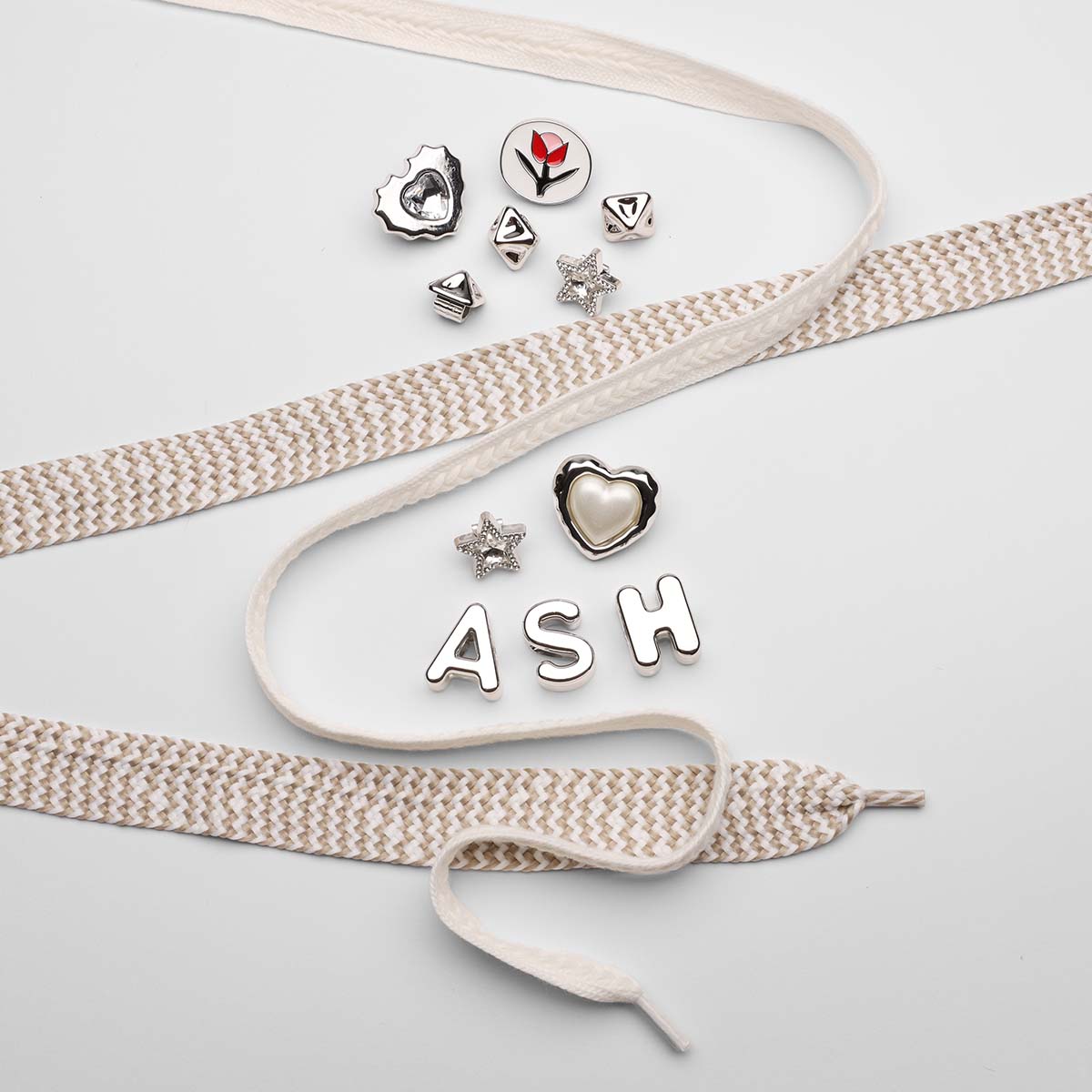 Cream-woven-laces-with-silver-charms-and-letters-ASH